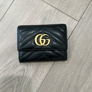 Black leather tri-fold Gucci wallet